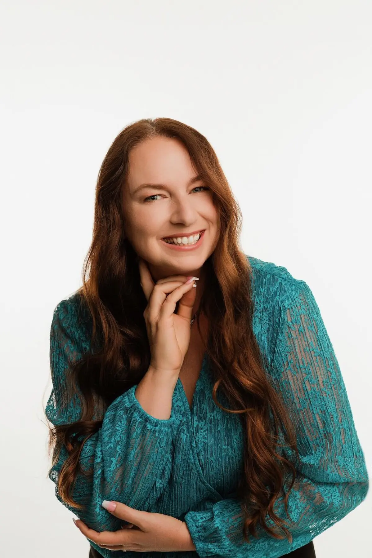 Larissa Mayfield in a teal blouse, studio portrait